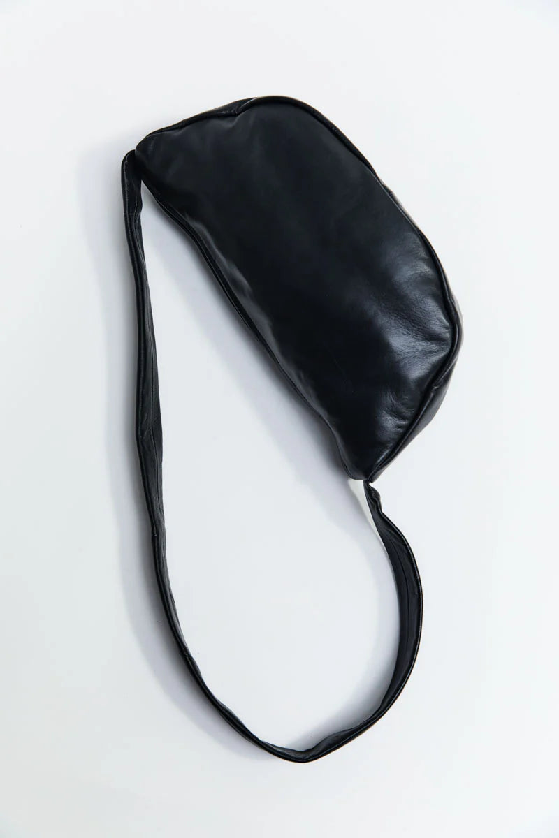 Black leather bag with a strap on a white background
