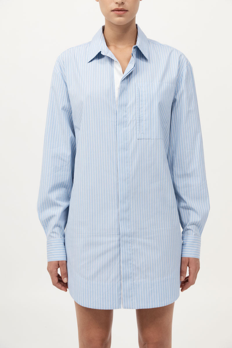 Light blue striped shirt dress worn by a person on a white background