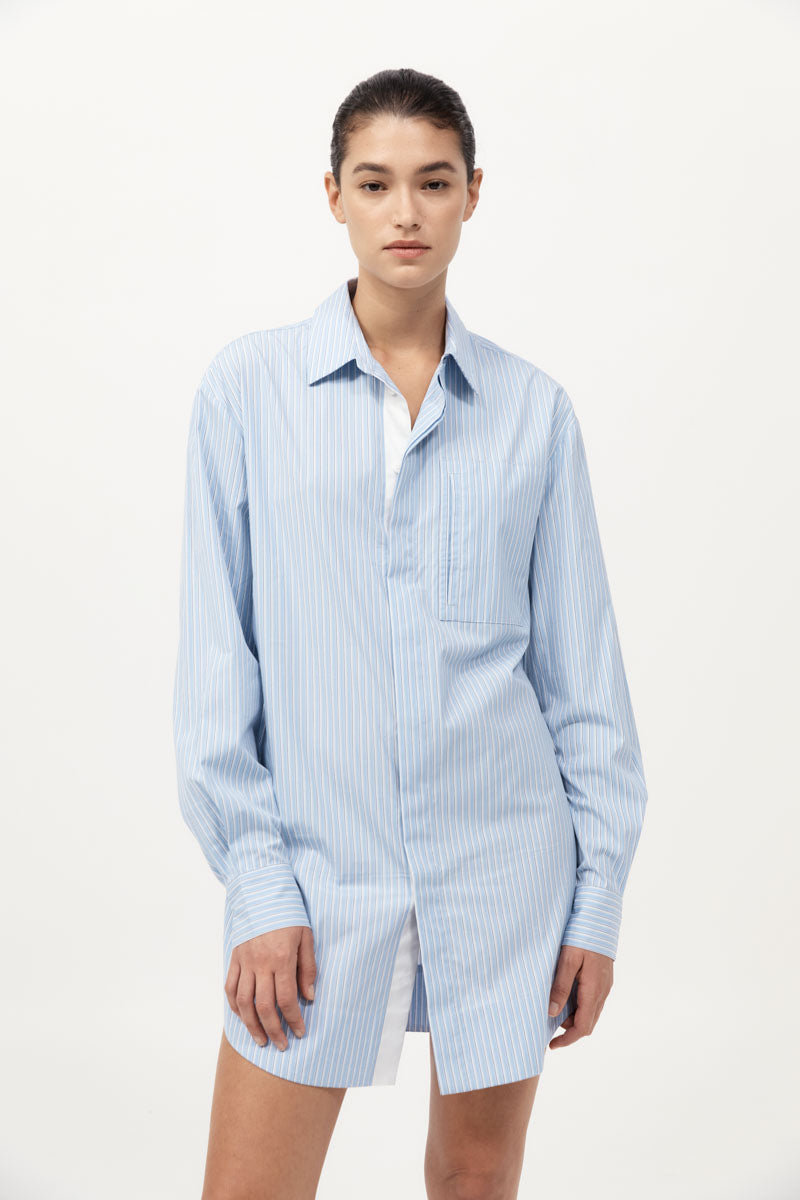Woman wearing a light blue striped shirt on a white background