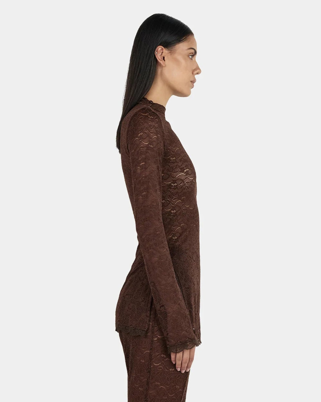 Clive Chocolate Lace Top — sheer long sleeves, longline, button‑opening at shoulder, on model, side view 