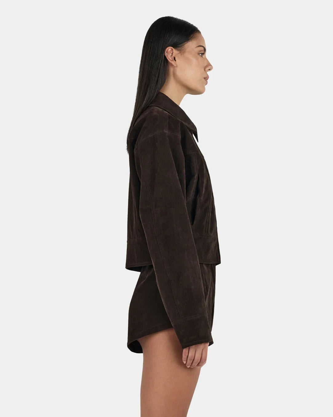 Gina Bomber Jacket in deep rum raisin suede with collar and seams — tailored bomber style, on model, side view 