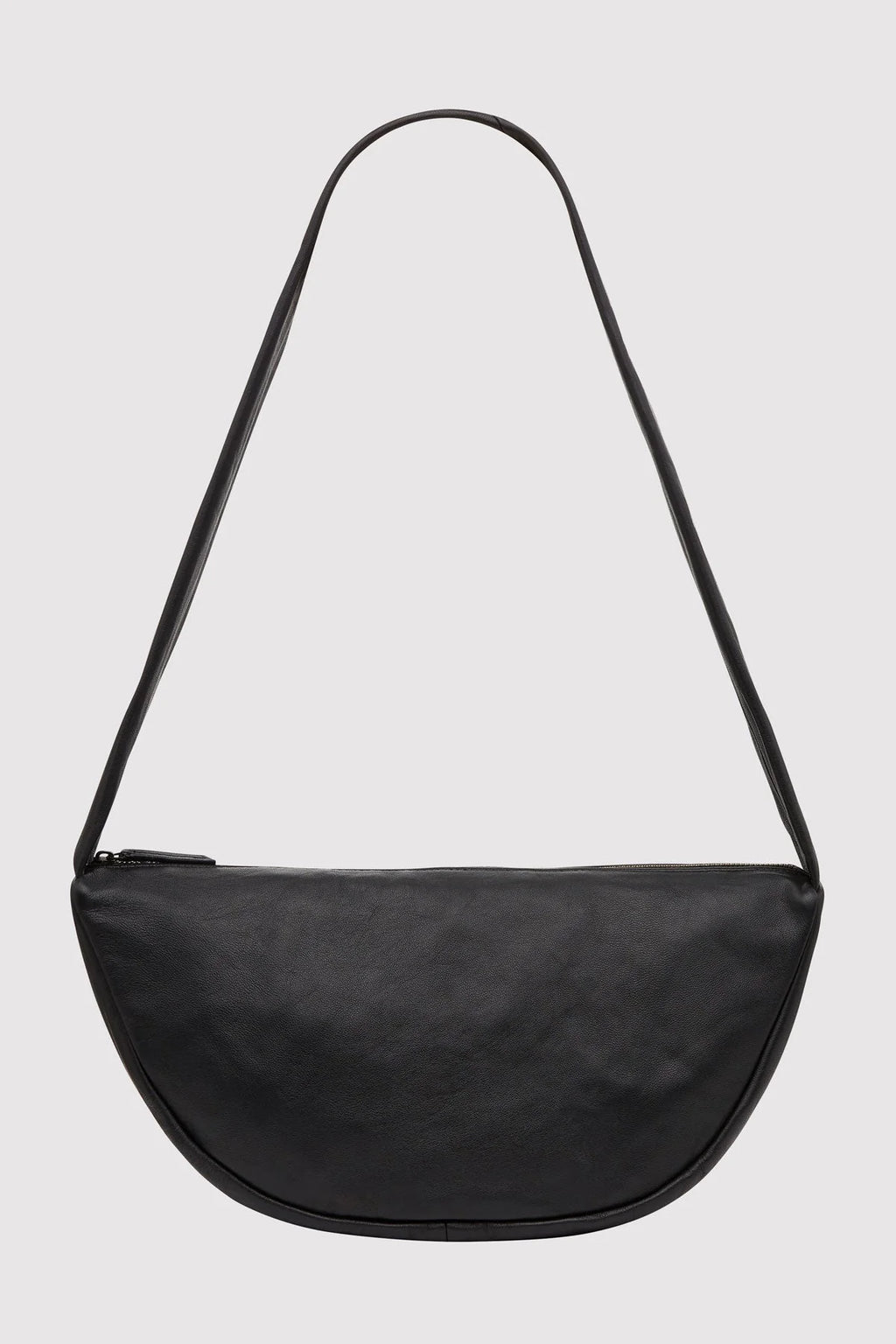 Black crossbody bag on a light gray background