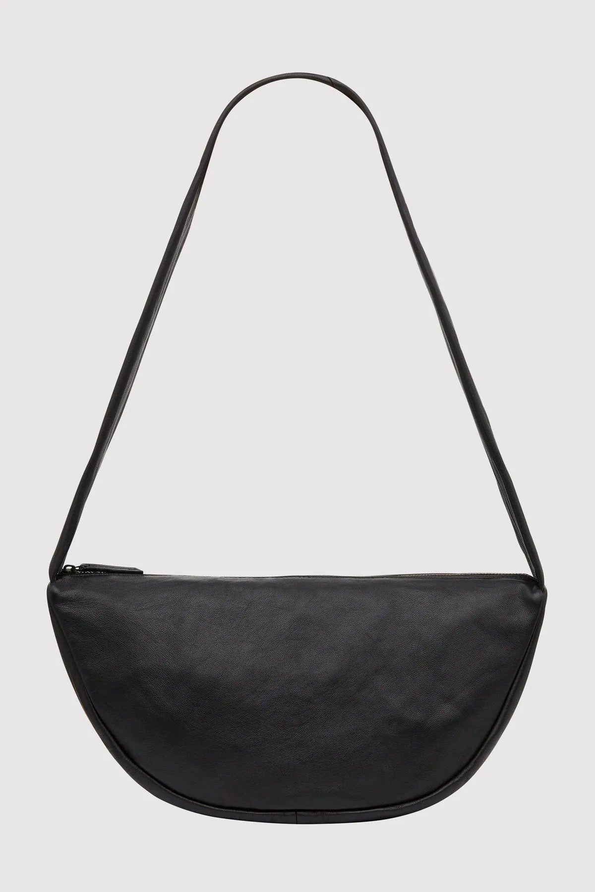 Black crossbody bag on a light gray background