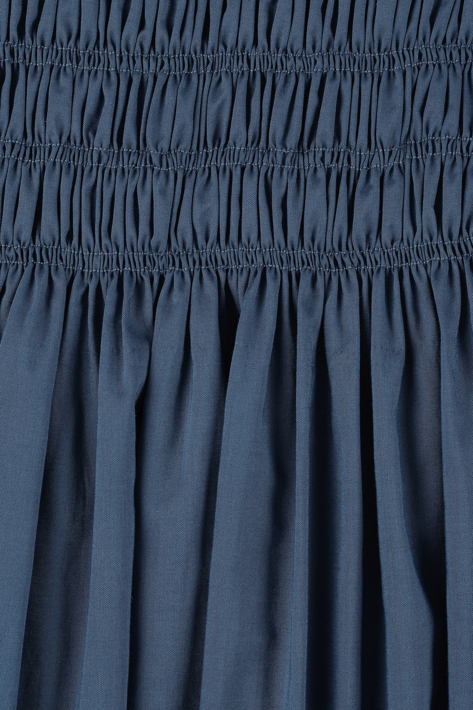 Close-up of a blue fabric with gathered waistband