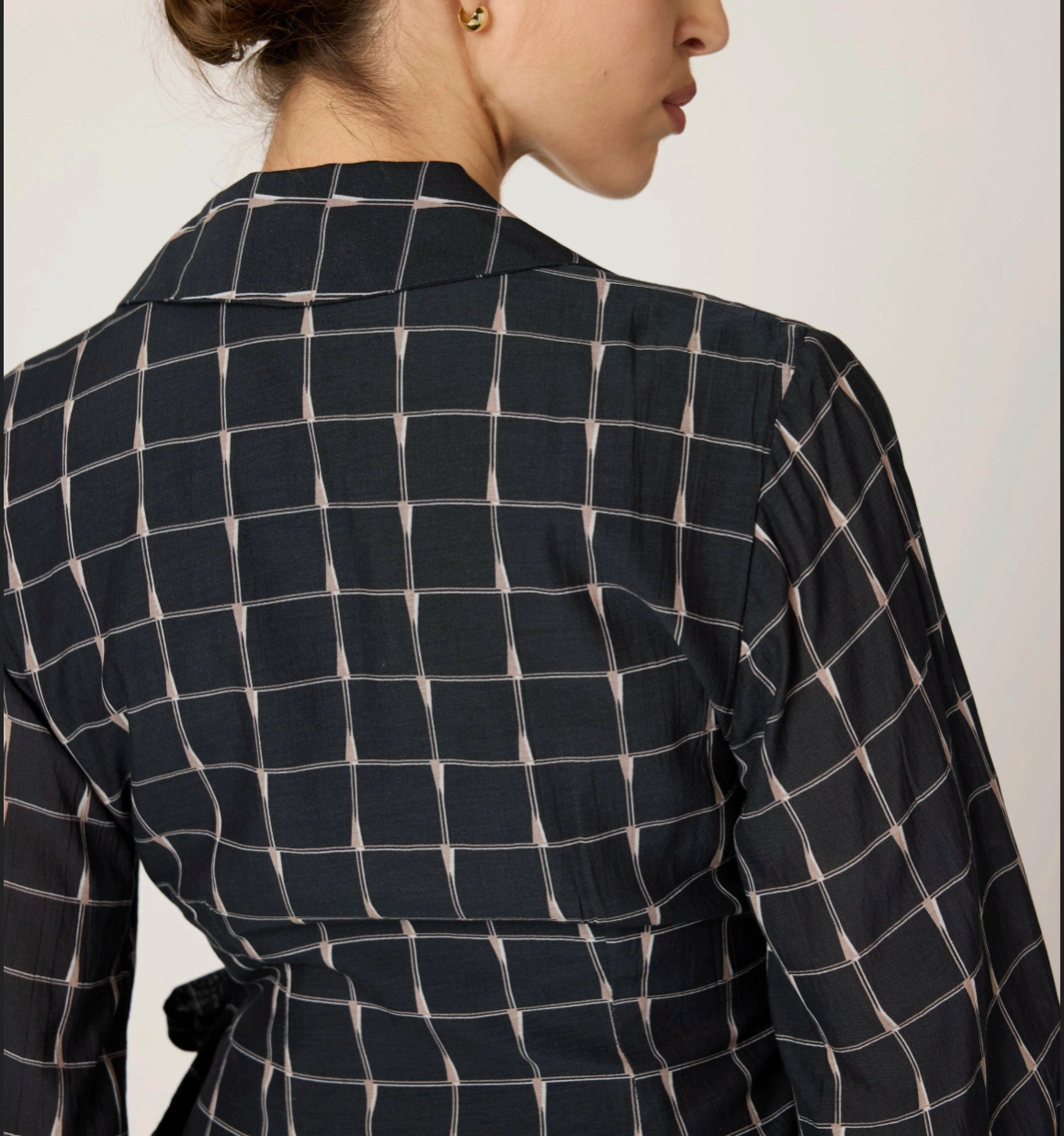 Back detail of Talia Mini Dress in checkered print — clean back seam and tailored finish.