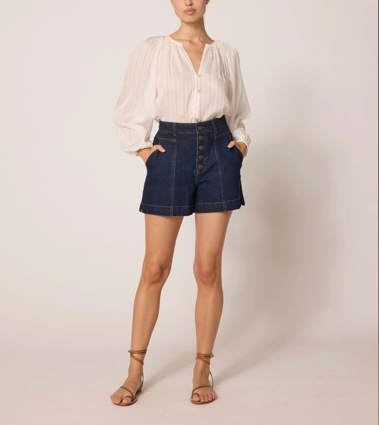 high waisted dark denim shorts with ivory top and strappy sandals