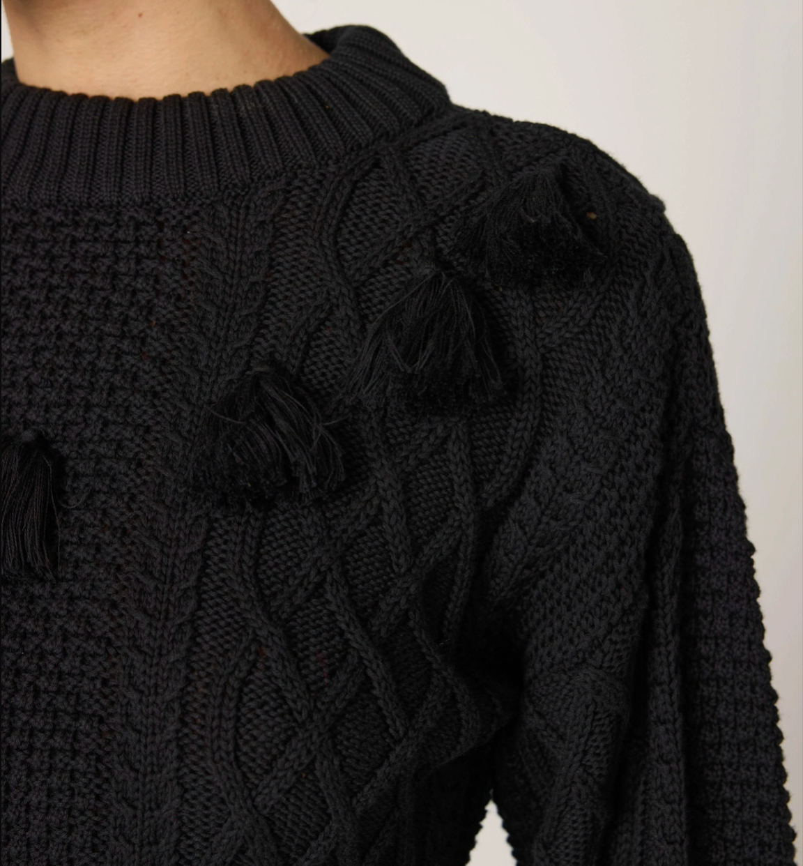 Detailed view of Cleobella Bettina Sweater in black — organic cotton tassel knit.